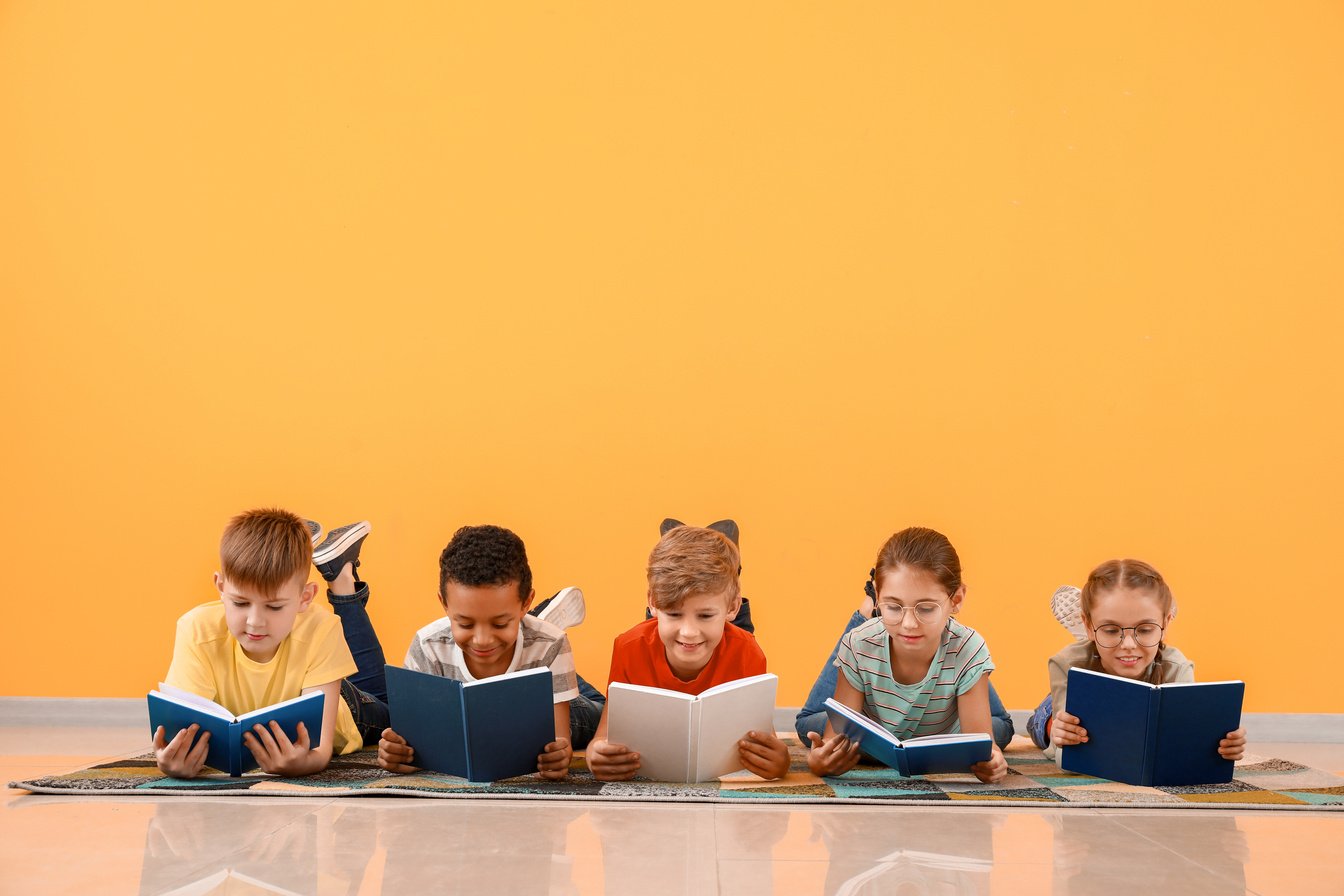 Cute Little Children Reading Books on Orange Background